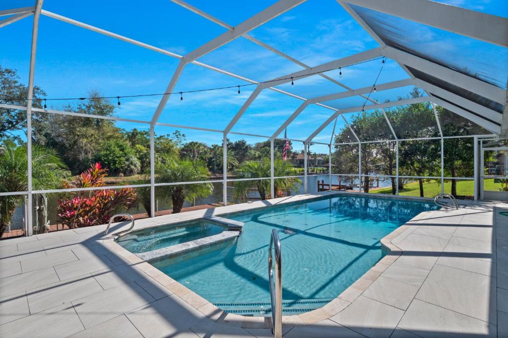 Palm Harbor House | SALTY TURTLE Luxury Salt Water Pool Home on Salt Water Canal with Tiki Bar