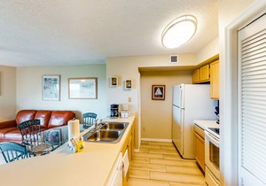 Coastal retreat with private balcony, pool, & easy beach access