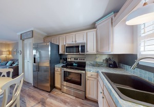 Cozy coastal condo close to beach access with shared pool, WiFi, & central AC