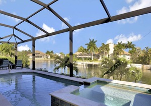 Picturesque waterfront home w/ heated pool, hot tub & outdoor kitchen