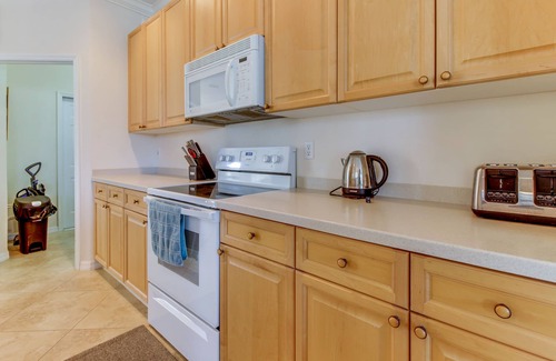 Biggar House | Spacious home with screened-in pool & lush lakefront views - minutes to beaches