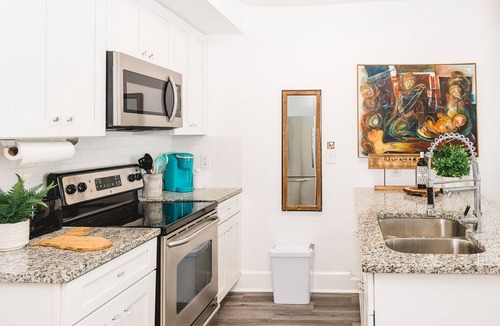 Historic Uptown House | An Art-Filled Garden Apartment Near Parks and Downtown