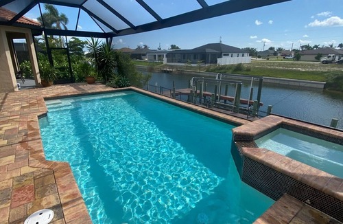 Trafalgar House | Casita Cabo Coral on Gulf Access Canal with Heated Salt Pool & Spa