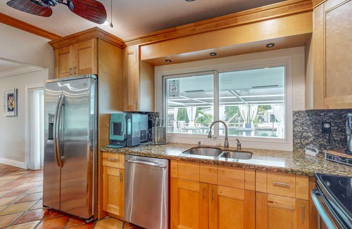 Nautilus Isle House | Cozy Home with pool, dock, canal view, fully equipped kitchen, dog friendly