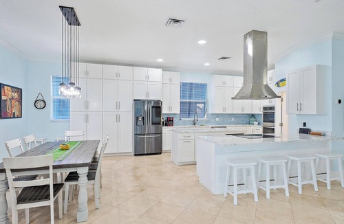 Palm City House | Deep water front home with private dock, pool, outdoor kitchen and pool table.