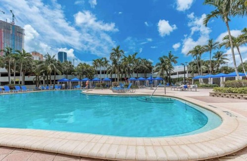 Aventura Condo | Entire condominium with a pool view, steps from the beach
