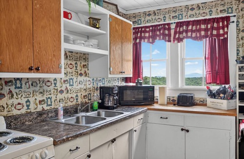 Galax House | Escape to this spacious countryside retreat featuring beautiful mountain views, a wraparound porch.