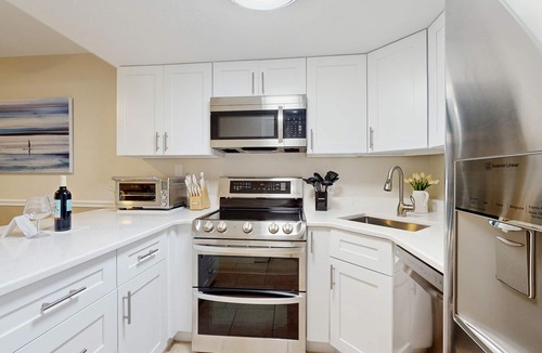 Cape Caneveral Beach Gardens Condo | Ground Floor Condo with Shared Heated Pool, High-Speed WiFi, and Central AC!