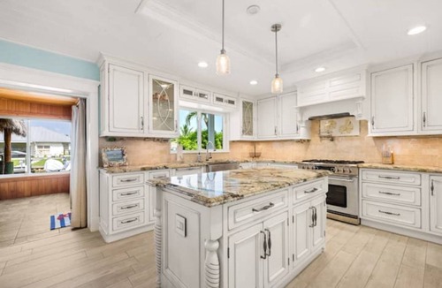 Palm City House | Light House Point Canal Front Pool Home with Dock and Ice Machine