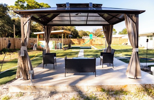 Fort Pierce North House | Located in tranquil Ft Pierce with game room, gazebo, outside bar, & playground.