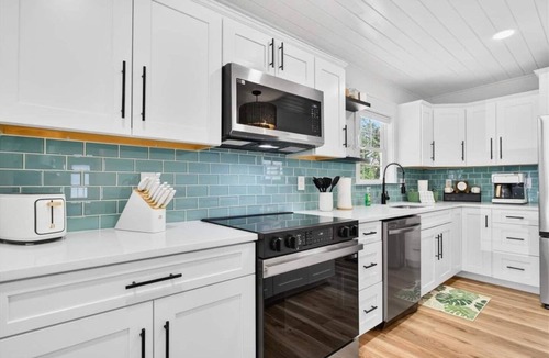Tranquil Harbour House | Oak Island Lux Cottage | Fenced Yard & Heated Pool!