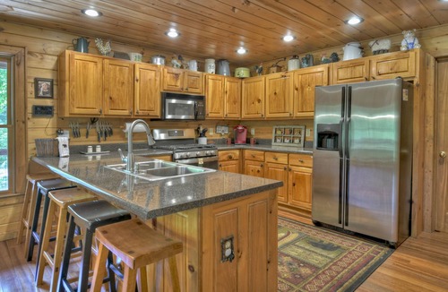 Cherry Log Cabin | Papa Bear Lodge is a Pet-friendly haven featuring hot tub, outdoor fireplace, firepit, pool table, WiFi, and secluded ambiance for unparalleled relaxation