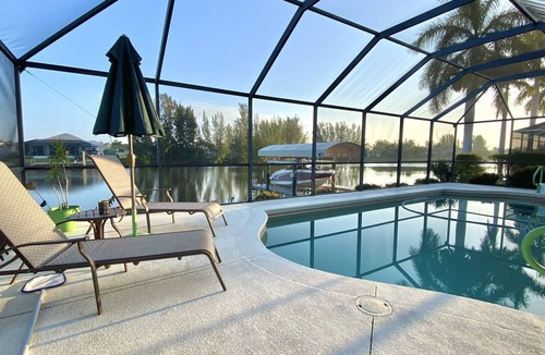Burnt Store House | Relax! Canal Home, Sunsets, Heated Pool, Lanai with TV, Boat Dock, Gulf Access
