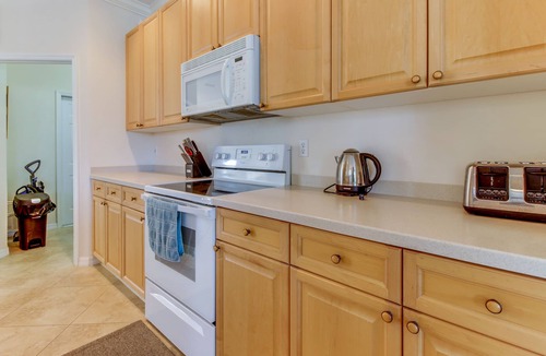 Biggar House | Spacious home with screened-in pool & lush lakefront views - minutes to beaches