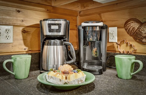 Cherry Log Cabin | Unleash adventure at Four Ridges! This pet-friendly haven offers a hot tub, firepit, WiFi, and doorstep hiking for boundless exploration