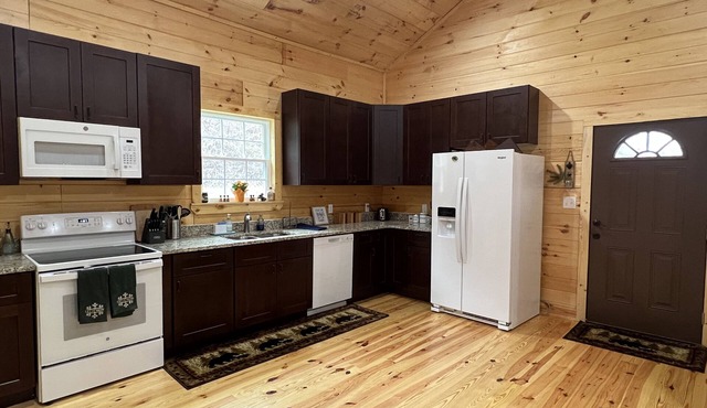 Riverfront Luxury Log Cabin with outside fire pit and deck overlooking the water