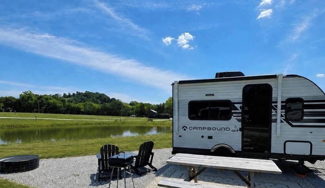 Stationary tiny camper in Winchester, TN with pond and mountain views.