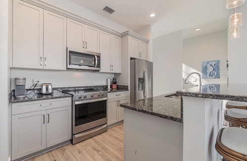 Cape Harbour Condo | 2 Story Lux Waterfront Living in Cape Harbour- Pool & Dock